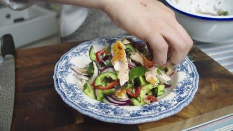 Chef-plating-a-salad-on-table-in-home-kitchen