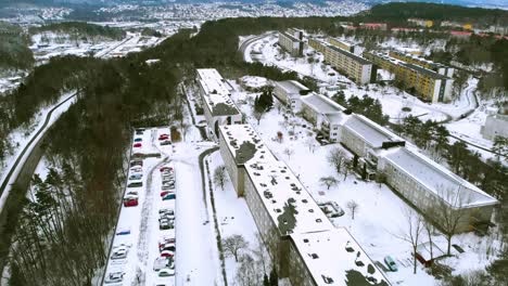 Aerial-view-over-city-all-covered-with-snow-during-winter