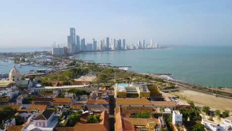 Aerial-View-of-Cartagena's-Old-City-with-Modern-Skyline,-Ocean-in-Background