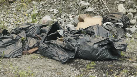 Cinematic-angle-of-beat-up-garbage-bags-left-out-in-the-wilderness