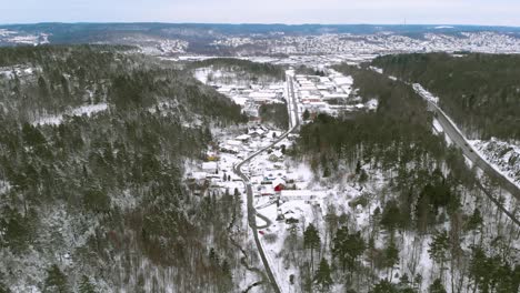 Birds-eye-view-of-winter-landscape-over-countryside-highway-during-extreme-winters