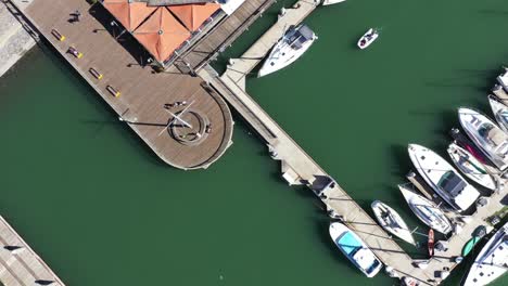 Top-down-view-of-dock-and-harbor-with-boats-docked-on-a-sunny-day-at-Jack-London-Square