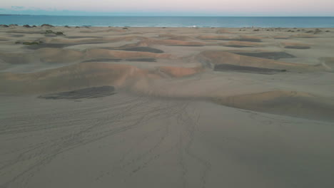 Stunning-aerial-shot-of-sandy-dunes-on-the-beach-of-Gran-Canaria-on-a-nice-day