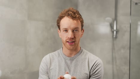 A-handsome-curly-man-applies-shaving-foam