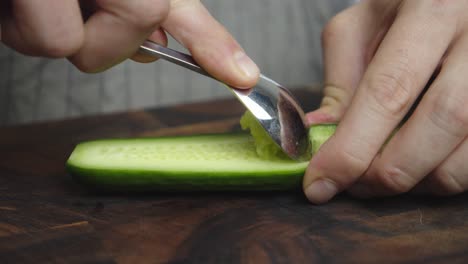 Removing-cucumber-pulp-with-metal-spoon