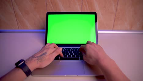 Man-Using-Chroma-key-screen-laptop-computer-on-desk-at-kitchen-stock-video