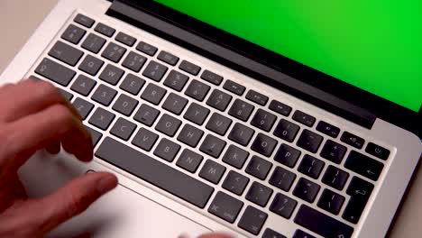 Close-up-Man-Using-Chroma-key-screen-laptop-computer-on-desk-at-home-stock-video