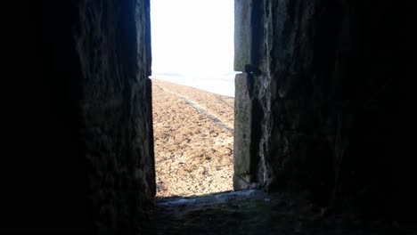 View-through-ancient-stone-castle-window-overlooking-moorland-highland-countryside-wilderness-dolly-right