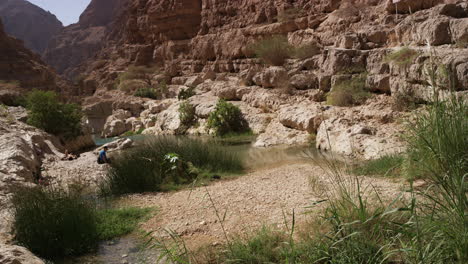 Sunny-day-at-the-turquoise-pools-of-Wadi-Shab-canyon,-Oman,-handheld-wide-shot