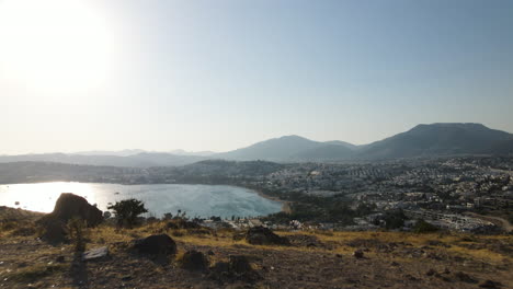 Cinematic-aerial-drone-shot-of-the-city-and-beach-of-beautiful-Turkish-city-called-Bodrum-on-a-sunny-day-with-blue-skies