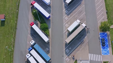 Parking-lot-with-semi-trucks-with-trailers-truck-rest-area---aerial-dolly-shot