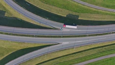 Static-overhead-aerial-of-traffic-on-highway-ramps-in-sunlight