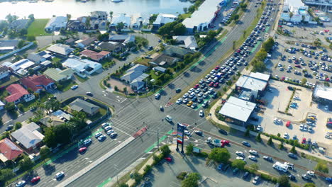 Aerial-Drone-Flyover-Busy-Intersection-With-Car-Traffic-In-Small-Town,-4K