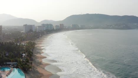 DRONE-SHOT-OF-MEXICAN-BEACH-OF-IXTAPA-ZIHUATANEJO-AFTER-SUNRISE