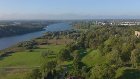 Beautiful-drone-of-Viljandi,-Estonia-in-summer-with-harbor,-green-grass-and-trees
