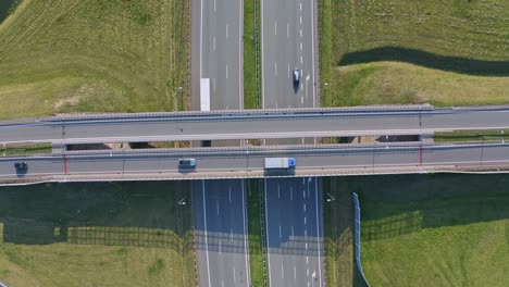Aerial-top-down-view-vehicles-driving-across-Icelandic-multi-level-highway-overpass-infrastructure