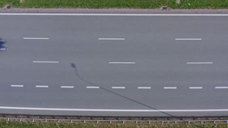 Multi-lane-European-highway-with-moderate-traffic-trucks-and-cars---top-down-aerial-shot