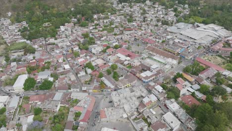Flying-over-the-houses-and-downtown-of-Panajachel,-Guatemala