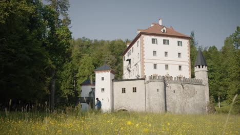 Wanderer-Zu-Fuß-Vor-Der-Schönen-Burg-Snežnik-Inmitten-Eines-Fichtenwaldes