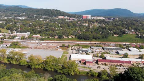 4K-Aerial-Drone-Video-of-Norfolk-Southern-Train-Yard-and-River-Arts-District-along-the-French-Broad-River-in-Asheville,-NC