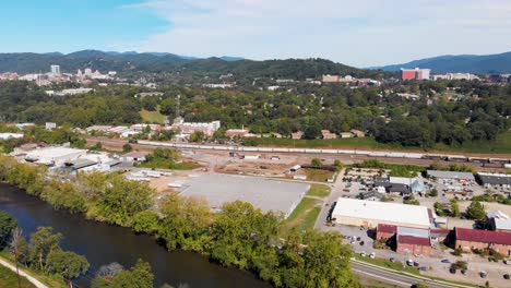 4K-Aerial-Drone-Video-of-Norfolk-Southern-Train-Yard-and-River-Arts-District-along-the-French-Broad-River-in-Asheville,-NC