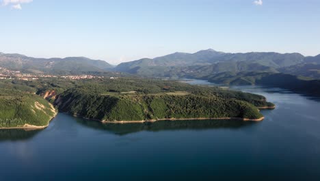 A-panoramic-view-of-a-stunning,-calm-lake-with-mountains-in-the-distance-near-Debar,-Macedonia
