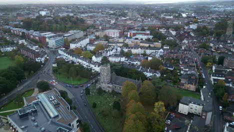 Early-morning-aerial-drone-flight-over-Exeter-City-Centre,-Devon,-England,-UK-from-St-David's-Church-to-Exeter-Cathedral