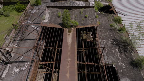 Fly-Over-Rusted-Roofs-Of-Abandoned-Industrial-Site-In-Khashuri,-Georgia