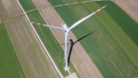 Aerial-orbit-over-the-windmill-standing-alone-in-the-middle-of-the-farm-fields
