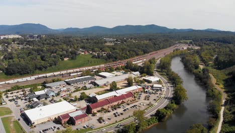 4K-Aerial-Drone-Video-of-French-Broad-River,-Norfolk-Southern-Train-Yard-and-River-Arts-District-in-Asheville,-NC