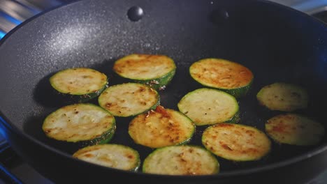 Fork-Used-In-Flipping-Slices-Of-Zucchini-Frying-In-A-Pan