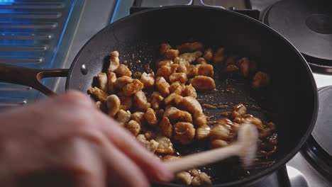 Cooking-And-Stirring-Chopped-Chicken-Breast-In-A-Skillet-With-Honey-And-Soy-Sauce