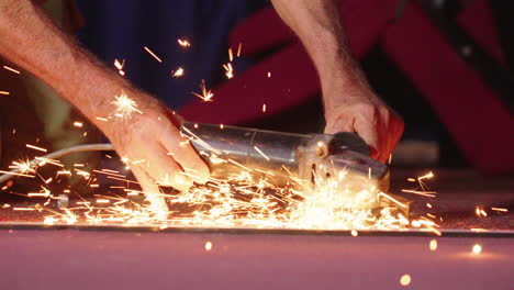 Close-Up-Tradesman-Using-Power-Tool-To-Grind-Bolt,-Causing-Sparks,-4K-Slow-Motion