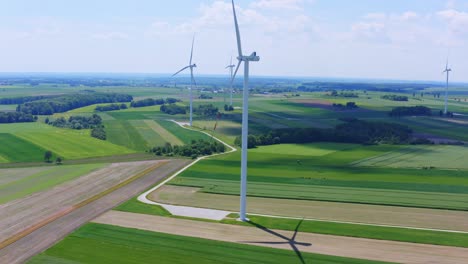 Panning-aerial-of-wind-turbines-in-open-crop-field-landscape-in-Poland