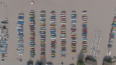 Aerial-footage-of-rows-of-kayaks-on-surfboards-on-a-beach-in-northern-Chicago
