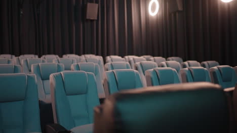 Dimly-Lit-Modern-Cinema-Seating-With-Light-Flickering,-4K
