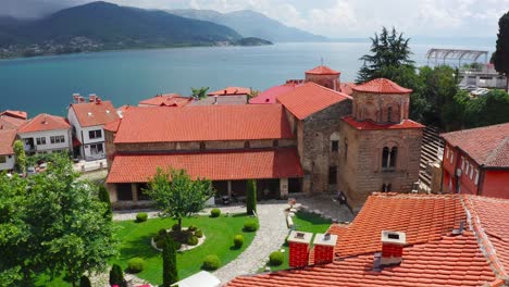 View-from-above-of-an-ancient-church-with-a-calm-lake-in-the-background-in-Ohrid,-Macedonia