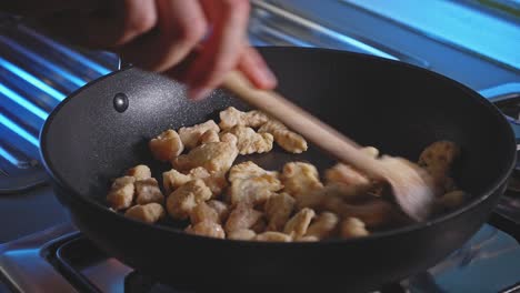Cooking-And-Stirring-Pan-Grilled-Chicken-Breast-In-Bite-size-Cuts