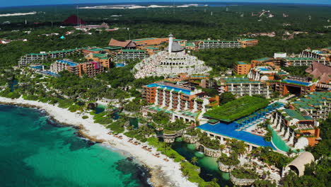 Flying-high-unveiling-the-beautiful-Xcaret-Arte-Resort-and-the-tropical-beach-in-Playa-del-Carmen,-Quintana-Roo,-Mexico