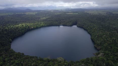 Lake-Eacham-With-Calm-Waters-In-Atherton-Tableland,-Queensland,-Australia---aerial-shot