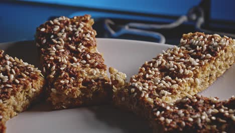 Healthy-And-Delicious-Vegetarian-Snack-Bars-Topped-With-Sesame-Seeds-In-A-Plate