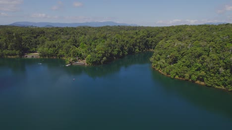 Flying-Over-Lake-Eacham-In-Atherton-Tableland,-Queensland,-Australia---drone-shot
