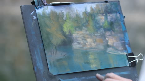 Close-up-footage-of-a-women-painting-with-pastels-outside
