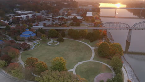 Rotating-aerial-footage-of-Coolidge-Park-in-Chattanooga,-Tennessee-during-the-sunrise