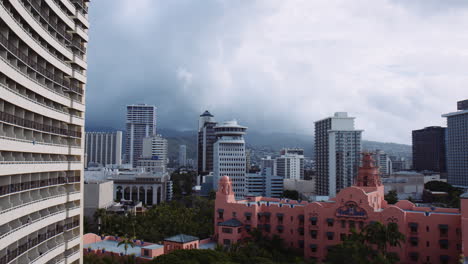 Royal-Hawaiian-Hotel-and-Highrise-Buildings,-view-towards-Honolulu-Watershed-Forest-Reserve,-Balconys-in-Foreground,-Hawaii