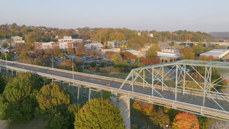 Aerial-flyover-of-the-Walnut-Street-walking-bridge-in-Chattanooga,-TN-with-the-north-shore-in-the-background