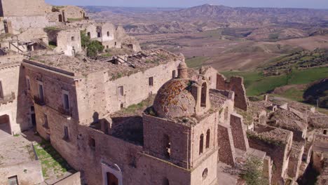 Old-church-of-Craco-bell-tower-in-deserted-ghost-town,-aerial