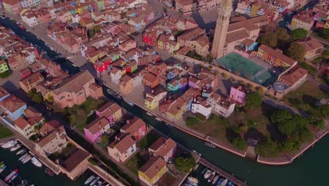 Colorful-island-village-Burano-with-narrow-canals-in-Italy,-aerial