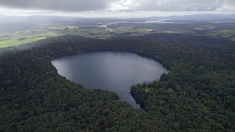 Eacham-Lake-With-Lush-Rainforest-In-Atherton-Tableland,-Queensland,-Australia---aerial-drone-shot