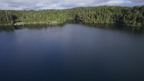 Lake-Eacham-With-Serene-Water-In-Atherton-Tablelands,-QLD,-Australia---aerial-drone-shot